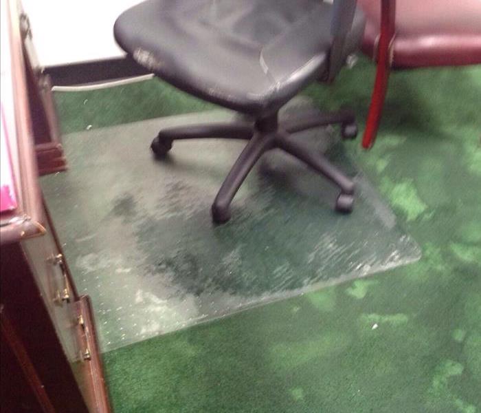 Water damage to a carpet in a office 