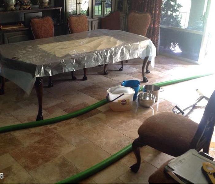 Water extracting hoses through a dining room
